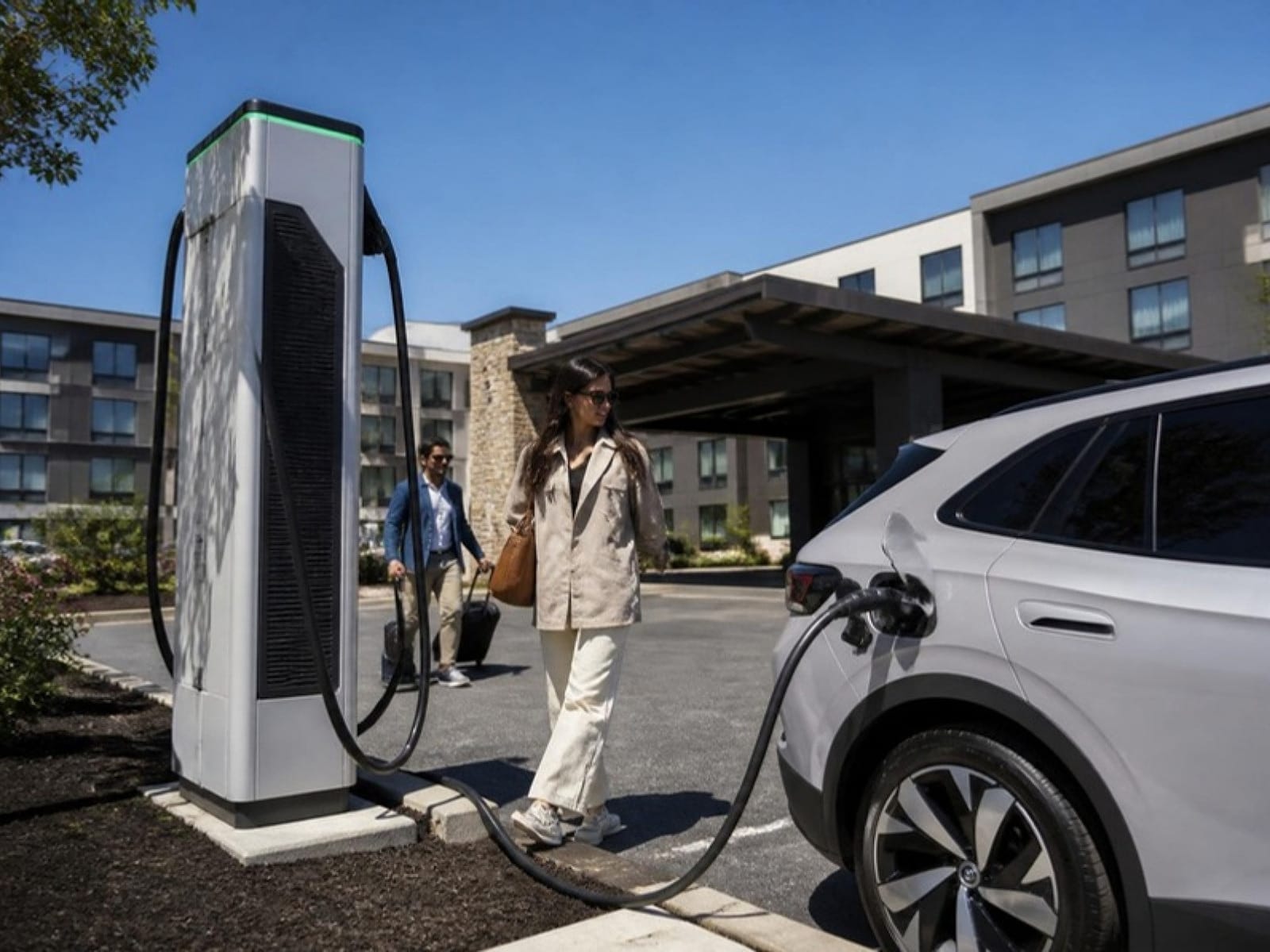 DC fast charging station with an electric car charging at a roadside hotel property